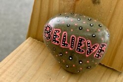 Someone is leaving rocks along a neighborhood trail to brighten the spirits of those who only leave the house to exercise or walk the dog. (Carolyn Presutti/VOA)