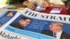 A news vendor counts her money near a stack of newspapers with a photo of U.S. President Donald Trump, right, and North Korea's leader Kim Jong Un on its front page on Friday, May 11, 2018, in Singapore. U.S. President Donald Trump will meet with North Korea's leader Kim Jong Un in Singapore on upcoming June 12, Trump announced in a Tweet Thursday. Singapore's diplomatic ties with North Korea and its relative proximity made the small Southeast Asian nation a natural choice for the historic summit between President Donald Trump and North Korean leader Kim Jong Un, analysts say. (AP Photo/Wong Maye-E) 