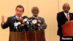 Chinese Foreign Minister Wang Yi (L), Tedros Adhanom, former Ethiopia's Foreign Minister, and Chair of the IGAD Council of Ministers and Sudan's Foreign Minister Ali Karti (C) after a meeting to support the Intergovernmental Authority on Development (IGAD)-led South Sudan peace process in Khartoum January 12, 2015.
