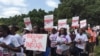 Protesters with signs march from Uhuru Park to the Supreme Court in Nairobi, Kenya, July 4, 2016. (J. Craig/VOA) 
