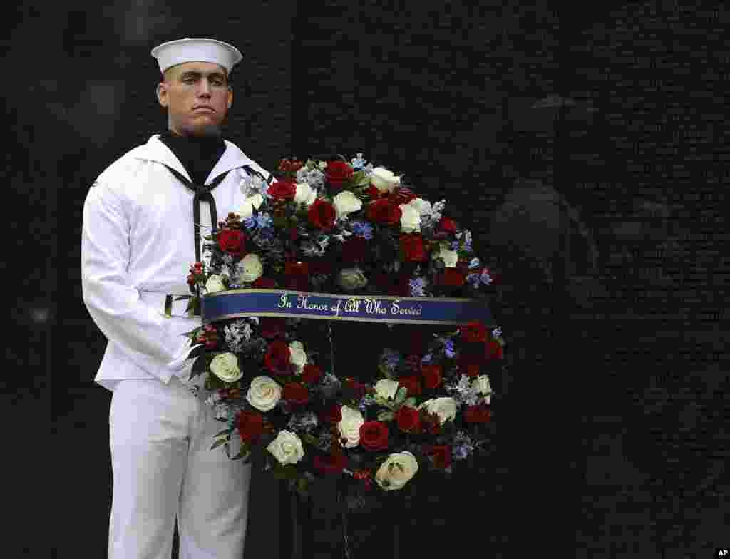U. S. Navy SN Caleb Harrington stands ready to assist Cindy McCain, wife of late Sen. John McCain, Secretary of Defense James Mattis and John Kelly, White House Chief of Staff, lay a wreath at the Vietnam Veterans Memorial in Washington, Sept. 1, 2018.