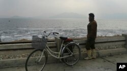 A North Korean man looks out to the sea as he stands on the West Sea Barrage in Nampo, North Korea, Feb. 2, 2019. North Korea's coast is a rich tidal power resource, one European official said.