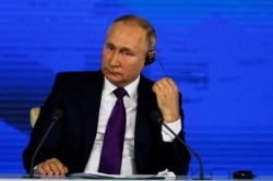 Russian President Vladimir Putin attends his annual end-of-year news conference in Moscow, Dec. 23, 2021.