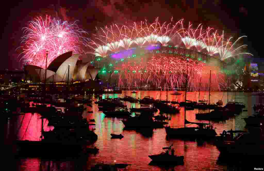 Fireworks explode over the Sydney Opera House and Harbour Bridge as Australia ushers in the New Year in Sydney, Jan. 1, 2017.