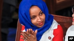 FILE - Rep. Ilhan Omar, D-Minn., listens to President Donald Trump's State of the Union speech, at the Capitol in Washington, Feb. 5, 2019.