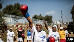 The "Boxing Gogos" (Grannies) stretch as they take part in a session hosted by the “A Team Gym” in Cosmo City in Johannesburg on September 19, 2017.