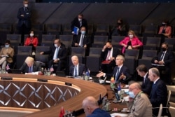 NATO Secretary General Jens Stoltenberg, center-right, opens a plenary session during a NATO summit at the alliance's headquarters in Brussels June 14, 2021.