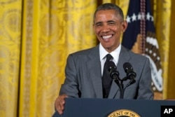 President Barack Obama smiles during an event with Young Southeast Asian Leaders Initiative fellows in the East Room of the White House, June 1, 2015.