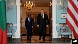 Secretary of State Mike Pompeo, right, arrives with Maldives Foreign Minister Abdulla Shahid, Wednesday, Feb. 20, 2019, at the Department of State in Washington. 