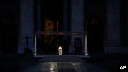 FILE - Pope Francis delivers the Urbi and Orbi prayer in an empty St. Peter's Square, at the Vatican, March 27, 2020.