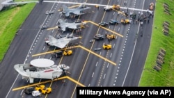 Taiwan war planes are parked on a highway during an exercise to simulate a response to a Chinese attack on its airfields in Changhua in southern Taiwan. (Military News Agency via AP, File)