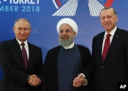 Iran's President Hassan Rouhani, center, flanked by Russia's President Vladimir Putin, left, and Turkey's President Recep Tayyip Erdogan, pose for photographs in Tehran, Iran, ahead of their summit to discuss Syria, Sept. 7, 2018.
