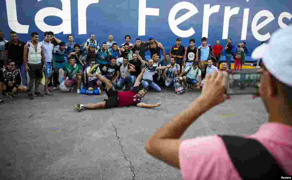 A group of Iraqi refugees pose for a photograph after disembarking the Blue Star Patmos passenger ship at the port of Piraeus, near Athens.