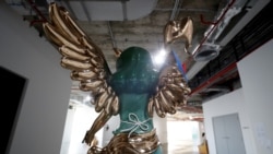 Thai artist Yuree Kensaku's sculpture titled "Broken Victoria", inspired by the Winged Victory of Samothrace statue of the Greek goddess Nike is seen during an exhibition at the Bangkok Art Biennale in Bangkok, Thailand December 4, 2020.