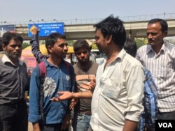 Cash shortages have eased, but Dhani Ram (in white shirt), a daily wage laborer, still finds it difficult to find work as the real estate sector continues to struggle. (A. Pasricha/VOA)