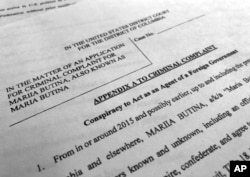 FILE - Court papers unsealed, July 16, 2018, photographed in Washington, shows part of the criminal complaint against Maria Butina.