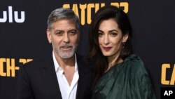 George Clooney and Amal Clooney arrive at the Los Angeles premiere of "Catch-22" at TCL Chinese Theatre, May 7, 2019.