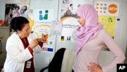 FILE - Actress and UN Population Fund's (UNFPA) Goodwill Ambassador Ashley Judd visits the Zaatari refugee camp in Mafraq, Jordan, April 10, 2016.