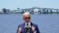 President Joe Biden speaks with the Interstate 10 Calcasieu River Bridge behind him, May 6, 2021, in Lake Charles, La. 