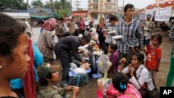 រូបឯកសារ៖ ពលករ​ចំណាកស្រុក​ខ្មែរ​ដែល​ត្រឡប់​ពី​ប្រទេស​ថៃ​វិញ​នាំគ្នា​ហូប​អាហារ​ពេលព្រឹក​ ខណៈ​ពេល​ដែល​ពួកគេ​រង់ចាំ​ជិះ​រថយន្ដឈ្នួល​ទៅ​កាន់​ស្រុក​កំណើត​របស់​ពួកគេវិញ​នៅ​ខេត្ត​កំពង់ស្ពឺ ក្នុង​ដំណើរ​ចេញ​ពី​ច្រក​ព្រំដែន​អន្តរជាតិ​ខ្មែរ​ថៃ នៅ​ប៉ោយប៉ែត ថ្ងៃ​ទី​១៨ ខែមិថុនា ឆ្នាំ​២០១៤។ 