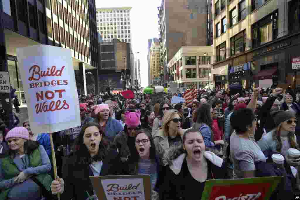 Protesters rally against President Donald Trump during a women&#39;s march Saturday, Jan. 21, 2017, in Chicago. The march is being held in solidarity with similar events taking place in Washington and around the nation. (AP Photo/Paul Beaty)