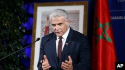 Israeli Foreign Minister Yair Lapid gestures as he speaks to media during a press conference in Casablanca, Morocco, Aug. 12, 2021. 
