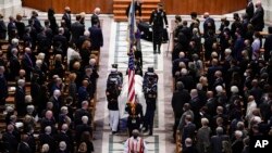 A military bearer team carries the casket after the funeral for former Secretary of State Colin Powell at the Washington National Cathedral, in Washington, Friday, Nov. 5, 2021. (AP Photo/Andrew Harnik)