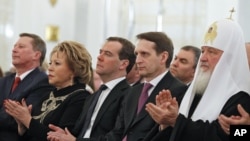 Russian dignitarites applaud before President Vladimir Putin's state-of-the nation address in the Kremlin in Moscow, Dec. 12, 2012.