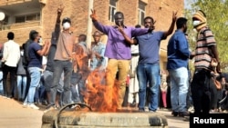 Sudanese demonstrators burn a tire as they participate in anti-government protests in Khartoum, Sudan, Jan. 17, 2019.
