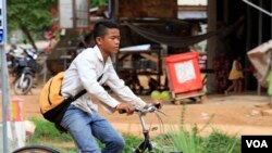 Chheum Sokhoch, 14, rides his bicycle home after school, Siem Reap, Cambodia, July 13, 2017.