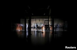 People sit during a blackout in Caracas, Venezuela, March 25, 2019.