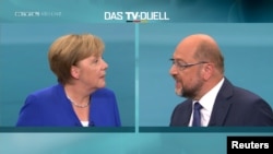 A screen that shows the TV debate between German Chancellor Angela Merkel of the Christian Democratic Union (CDU) and her challenger Germany's Social Democratic Party SPD candidate for chancellor Martin Schulz in Berlin, Germany, Sept. 3, 2017.