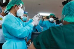 FILE: Health workers prepare to administer the COVID-19 vaccine at the Ayeyarwaddy COVID treatment center, Wednesday, Jan.27, 2021, in Yangon, Myanmar.