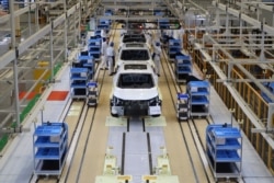 FILE - Workers are seen on the production line at Honda Motor's new joint venture plant with Dongfeng Motor Group in Wuhan, Hubei province, China April 12, 2019. (REUTERS/Norihiko Shirouzu)