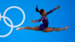 FILE- Simone Biles, of United States, performs her floor exercise routine during the women's artistic gymnastic qualifications at the 2020 Summer Olympics, Sunday, July 25, 2021, in Tokyo. (AP Photo/Ashley Landis)