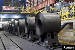 FILE - Rolled steel is seen after being treated on the pickle line at the Severstal steel mill in Dearborn, Michigan, June 21, 2012.