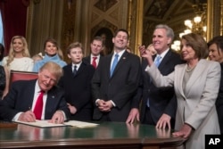 President Donald Trump is joined by the congressional leadership and his family as he formally signs his cabinet nominations into law, in the President's Room of the Senate, at the Capitol in Washington, Jan. 20, 2017.