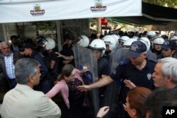 Police officers detain a pro-Kurdish Peoples' Democratic Party member as they protest the detention of Co-mayors Gultan Kisanak and Firat Anli, in Diyarbakir, Turkey, Oct. 26, 2016.