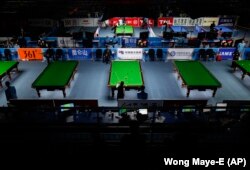 Competitors are seen playing in the billards event at the Asian Games in Guangzhou, China, 2010. (AP Photo/Wong Maye-E)