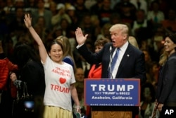 Republican presidential candidate Donald Trump interacts with Asian-American supporter during rally at Anaheim Convention Center, May 25, 2016.