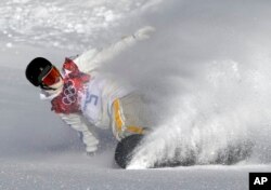 Sweden's Niklas Mattsson finishes his first run during men's snowboard slopestyle qualifying at the Rosa Khutor Extreme Park ahead of the 2014 Winter Olympics, Feb. 6, 2014, in Krasnaya Polyana, Russia.