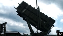 Taiwanese soldiers perform a launch preparation exercise on one of Taiwan's many Patriot missile air defense systems Friday, Oct. 22, 2004