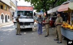 Sri Lankan police officers perform a security check on a truck at a roadside in Colombo, Sri Lanka, April 25, 2019.