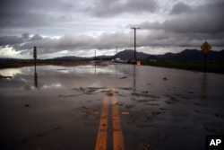 Water covers a closed Las Posas Road near Camarillo, Calif., after heavy rain from the first in a series of El Nino storms passed over the area on, Jan. 6, 2016.