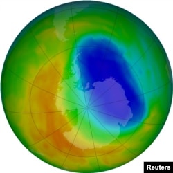 FILE - A false-color view of total ozone over the Antarctic pole is seen in this NASA handout image released Oct. 24, 2012. The purple and blue colors are where there is the least ozone. The average area covered by the Antarctic ozone hole in that year was the second smallest in two decades, at 8.2 million square miles; in September 2017, it was 7.6 million square miles.