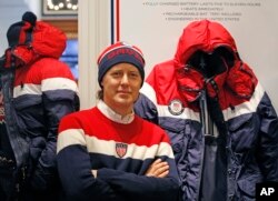 David Lauren poses beside Team USA's Opening Ceremony parka, which features a battery-powered heating element inside to keep athletes warm during the Winter Olympics in Pyeongchang, South Korea, Monday, Jan. 22, 2018, in New York.