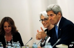 U.S. Secretary of State John Kerry and Under Secretary for Political Affairs Wendy Sherman, center, meet with foreign ministers during the current round of nuclear talks with Iran being held in Vienna, Austria, July 10, 2015.