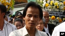 FILE: Chea Mony, the former Free Trade Union leader, walk during a march to mark the 10th anniversary in remembrance of Chea Vichea on his assassination, in Phnom Penh, Cambodia, Wednesday, Jan. 22, 2014. (AP Photo/Heng Sinith)
