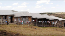 FILE PHOTO: Josephine Wanjiru, 19, carries her child outside a class at the Serene Haven secondary school, accommodating pregnant girls and teenage mothers with their babies in Nyeri, Kenya January 20, 2021. REUTERS/Monicah Mwangi