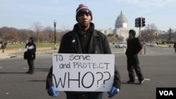 A protester displays a sign carried during the "Justice for All" march in Washington, Dec. 13, 2014.